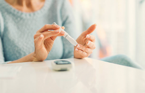 woman using diabetes test kit