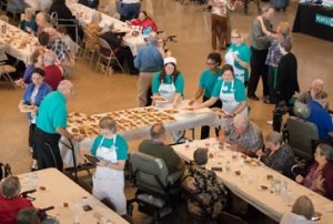 Peoples Health employees serving Thanksgiving meals to seniors in Houma.