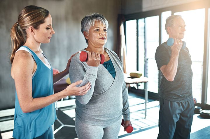 Image of seniors lifting weights in fitness class
