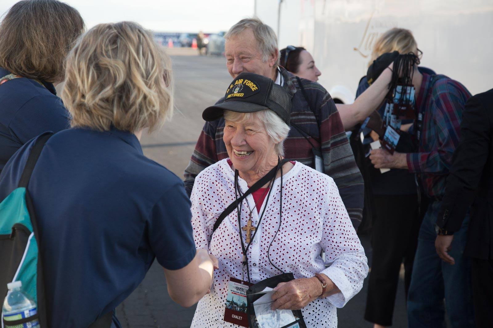 Peoples Health employee greeting attendee at the WWII veterans event at the Lakefront air show