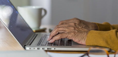man typing on laptop