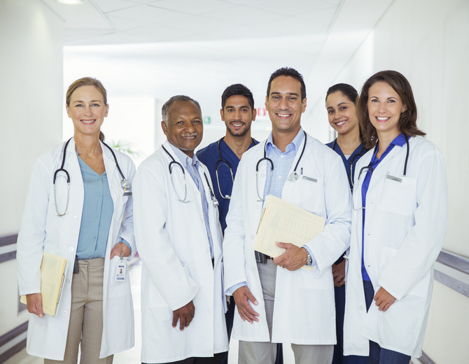 Doctors and nurses smiling in hospital hallway