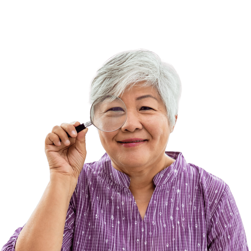 Senior woman looking through a magnifying glass and smiling