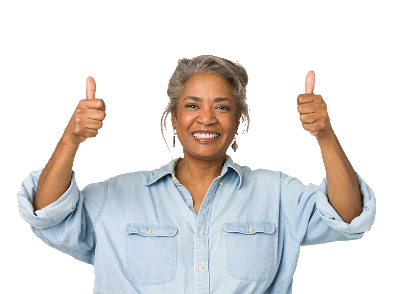 Senior woman wearing a blue jean shirt smiling, giving two thumbs up