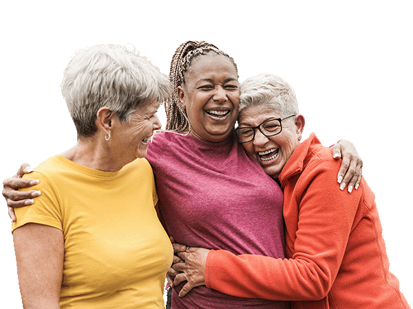 Three senior women embracing.